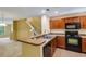 Modern kitchen with breakfast bar, open layout and stainless steel sink at 9013 White Sage Loop, Lakewood Ranch, FL 34202