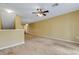 Bright and airy carpeted living room with a ceiling fan and access to other rooms at 9013 White Sage Loop, Lakewood Ranch, FL 34202