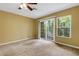 Carpeted living room with window and sliding doors at 9013 White Sage Loop, Lakewood Ranch, FL 34202