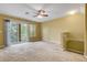 Carpeted living room with windows and sliding doors leading to balcony at 9013 White Sage Loop, Lakewood Ranch, FL 34202