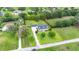 Large property with mature landscaping featuring house, pool, and defined lot lines at 9830 Caribou Trl, Dade City, FL 33525