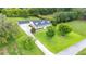 Expansive property featuring a well-manicured lawn, mature trees, and a stately home at 9830 Caribou Trl, Dade City, FL 33525