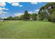 Expansive green backyard with mature trees offering plenty of space and privacy at 9830 Caribou Trl, Dade City, FL 33525