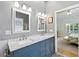 Bathroom featuring a double sink vanity with marble countertop and view of a bedroom at 9830 Caribou Trl, Dade City, FL 33525