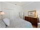 Spacious bedroom boasts closet, dresser with a mirror, and a ceiling fan for added comfort at 9830 Caribou Trl, Dade City, FL 33525