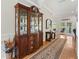 Foyer with hardwood floors, china cabinet and view to the backyard at 9830 Caribou Trl, Dade City, FL 33525
