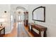 Inviting foyer with hardwood floors, elegant furnishings, and arched doorways at 9830 Caribou Trl, Dade City, FL 33525