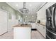 Spacious kitchen with a cooking island, modern appliances, and white cabinets at 9830 Caribou Trl, Dade City, FL 33525