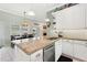 Bright kitchen featuring a center island, stainless steel appliances, and an eat-in dining area at 9830 Caribou Trl, Dade City, FL 33525