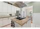 Well-equipped kitchen with an island cooktop, stainless steel fridge, and modern fixtures at 9830 Caribou Trl, Dade City, FL 33525
