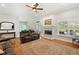 Inviting living room with a marble fireplace, ceiling fan, and access to the backyard at 9830 Caribou Trl, Dade City, FL 33525