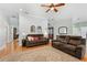 Open-concept living room boasting hardwood floors, comfortable seating, and great lighting at 9830 Caribou Trl, Dade City, FL 33525