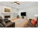 Spacious living room featuring a fireplace, ceiling fan, and a window with natural light at 9830 Caribou Trl, Dade City, FL 33525