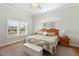 Main bedroom showcases a window and a decorative headboard with warm lighting at 9830 Caribou Trl, Dade City, FL 33525