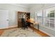 Office featuring hardwood floors, built-in hutch and desk, natural light, and neutral walls at 9830 Caribou Trl, Dade City, FL 33525