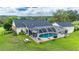 A screened-in pool is a perfect addition for relaxation and recreation, surrounded by a green backyard at 9830 Caribou Trl, Dade City, FL 33525