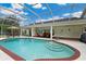 Relaxing screened-in pool area with plenty of seating and outdoor dining space at 9830 Caribou Trl, Dade City, FL 33525