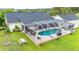 Enjoy the screened-in pool area, perfect for lounging and outdoor entertaining, surrounded by mature trees at 9830 Caribou Trl, Dade City, FL 33525