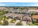Aerial view of a suburban community featuring well-maintained homes and a scenic pond with a fountain at 11314 American Holly Dr, Riverview, FL 33578