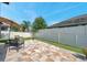 Spacious backyard featuring a tiled patio area with outdoor seating and a well-maintained lawn with fence at 11314 American Holly Dr, Riverview, FL 33578