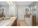 Well-lit bathroom with double sinks, a soaking tub, and a glass-enclosed shower at 11314 American Holly Dr, Riverview, FL 33578