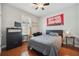 This bedroom features neutral colors, wood floors, ceiling fan, and a large window at 11314 American Holly Dr, Riverview, FL 33578