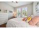 Comfortable bedroom with wood floors, plantation shutters, and a neutral color palette at 11314 American Holly Dr, Riverview, FL 33578