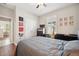 This bedroom features wood floors, neutral colors, a ceiling fan, and a large window at 11314 American Holly Dr, Riverview, FL 33578
