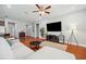 Spacious living room featuring hardwood floors, a ceiling fan, and comfortable seating at 11314 American Holly Dr, Riverview, FL 33578
