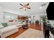 Open-concept living area with hardwood floors connecting the living and kitchen spaces at 11314 American Holly Dr, Riverview, FL 33578