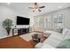 Open-concept living room with a comfortable sectional, large TV, and stylish decor at 11314 American Holly Dr, Riverview, FL 33578