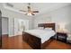 An inviting Primary bedroom with wood floors and an ensuite bathroom at 11314 American Holly Dr, Riverview, FL 33578