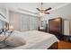 The Primary bedroom boasts wood floors, a ceiling fan, and lots of natural light at 11314 American Holly Dr, Riverview, FL 33578