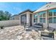 Inviting outdoor patio featuring stylish seating, a tiled floor, and a screened lanai for relaxed living at 11314 American Holly Dr, Riverview, FL 33578