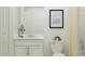 Clean bathroom featuring a modern vanity, minimalist decor, and ample lighting, creating a refreshing and functional space at 11737 Brae Way, Dade City, FL 33525