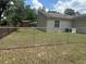 A view of the home's backyard, enclosed with chain link and wood fencing at 11814 Washington St, Seffner, FL 33584