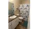 Bathroom featuring a white vanity, tile floor, and a shower with decorative curtains at 11814 Washington St, Seffner, FL 33584