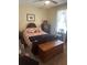 Cozy bedroom with a plush bed, vintage furniture, and natural light at 11814 Washington St, Seffner, FL 33584
