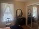Bedroom with natural light and a mirrored closet next to the vintage dresser at 11814 Washington St, Seffner, FL 33584