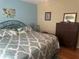 Comfortable bedroom with a queen bed featuring stylish linens and decorative pillows at 11814 Washington St, Seffner, FL 33584