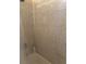 Tiled shower featuring neutral-colored tiles and a shower curtain at 11814 Washington St, Seffner, FL 33584