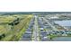 Drone shot exhibits the long neighborhood streets filled with residences and houses located beside a retention pond at 11847 Brighton Knoll Loop, Riverview, FL 33579