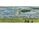 Bird's eye view of neighborhood featuring numerous single Gathering houses in rows, lakes, and green spaces at 11847 Brighton Knoll Loop, Riverview, FL 33579