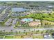 Wide aerial shot of a planned community with community pool, playground, and a serene lake at 11847 Brighton Knoll Loop, Riverview, FL 33579