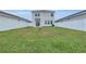 Spacious back yard with well-maintained green grass and a white fence providing privacy at 11847 Brighton Knoll Loop, Riverview, FL 33579