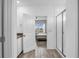Bathroom view showing a tile shower stall, toilet, sink with white cabinets, and bedroom doorway at 11847 Brighton Knoll Loop, Riverview, FL 33579