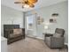 Light and airy Bedroom with a wooden crib, neutral rug, and a comfortable rocking chair at 11847 Brighton Knoll Loop, Riverview, FL 33579