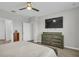 Spacious bedroom with a television, dresser, and an ensuite bathroom entrance at 11847 Brighton Knoll Loop, Riverview, FL 33579