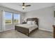 Comfortable bedroom with two windows, ceiling fan, and a wooden bed with white pillows at 11847 Brighton Knoll Loop, Riverview, FL 33579