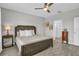 Relaxing bedroom with a wooden bed, side table with a lamp, and neutral color scheme at 11847 Brighton Knoll Loop, Riverview, FL 33579